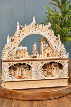 14.75" Lighted Laser Cut Wood Village Scene with Moving Figurine and Candles